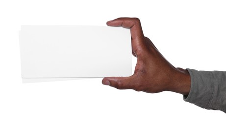 Photo of African American man holding flyers on white background, closeup. Mockup for design