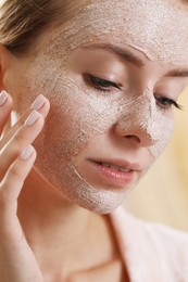 Photo of Woman with face mask on blurred background, closeup. Spa treatments