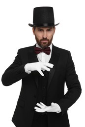 Magician in top hat holding something on white background