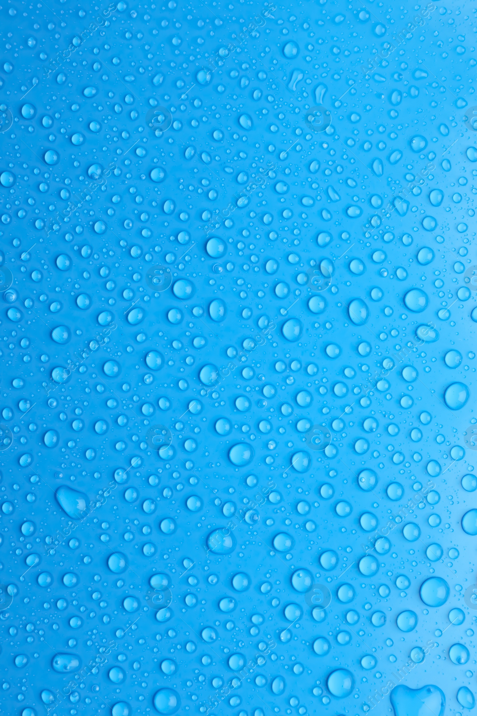 Photo of Water drops on light blue background, top view