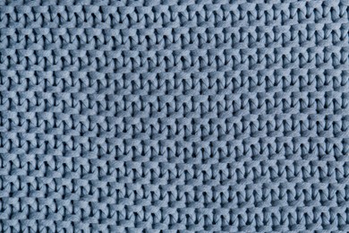 Photo of Beautiful light blue knitted fabric as background, top view