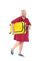 Senior woman with suitcase on white background. Vacation travel