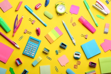 Photo of School stationery on yellow background, flat lay. Back to school