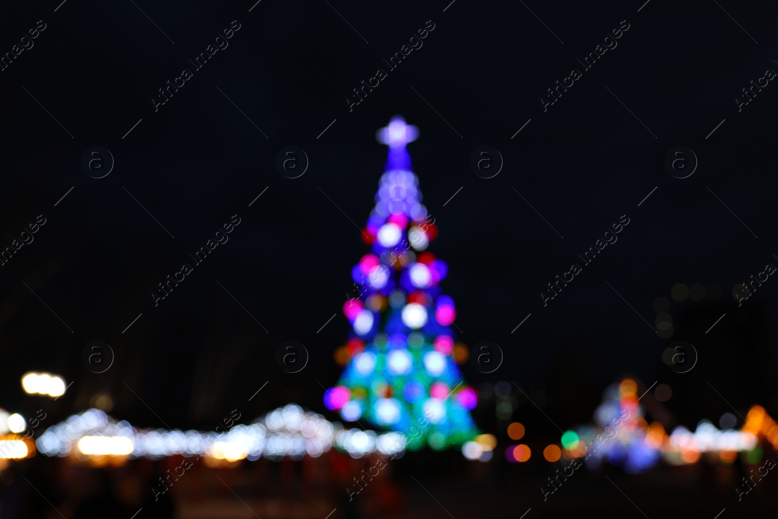 Photo of Beautiful decorated Christmas tree outdoors. Bokeh effect