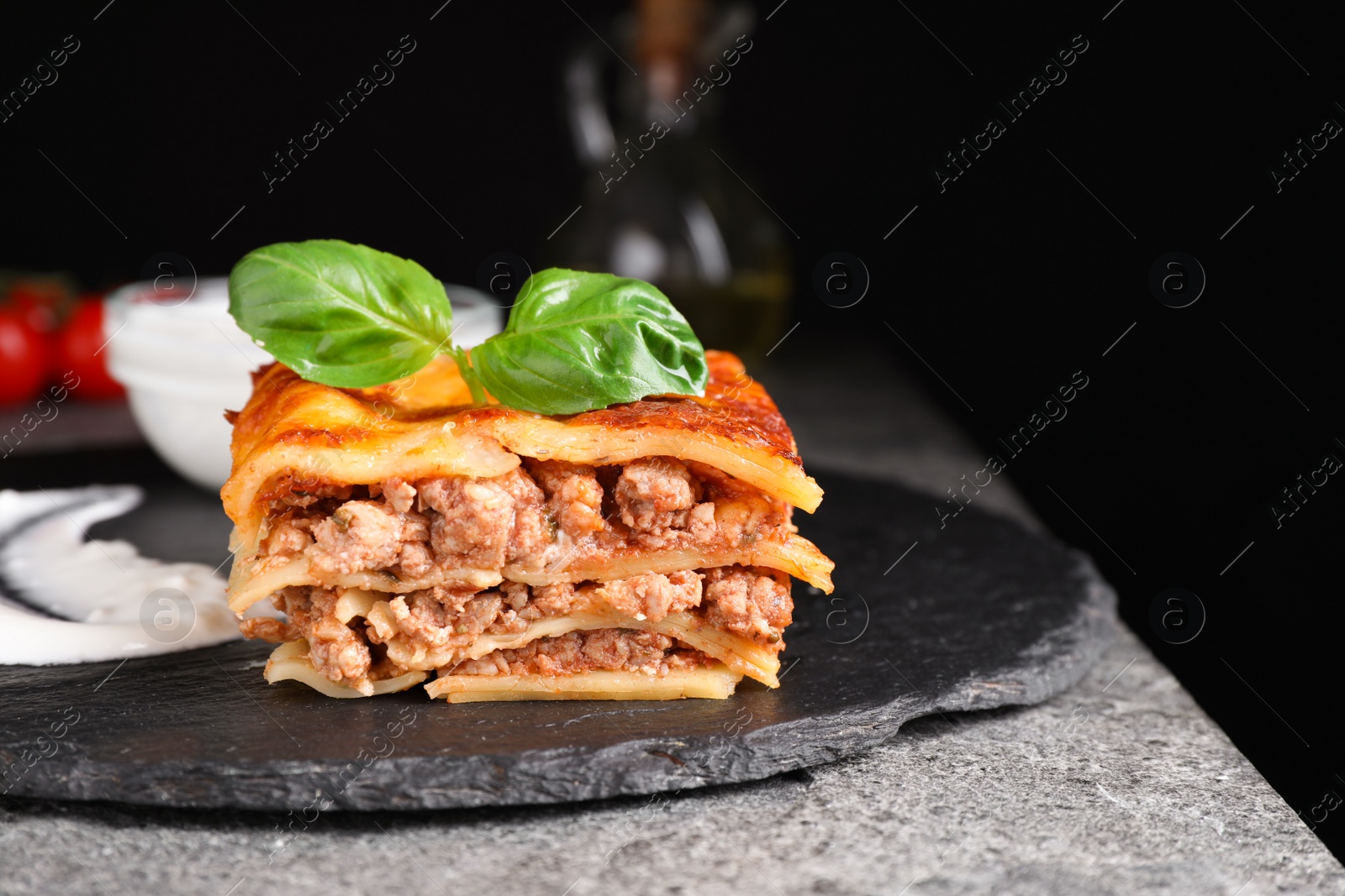 Photo of Delicious cooked lasagna served on slate plate