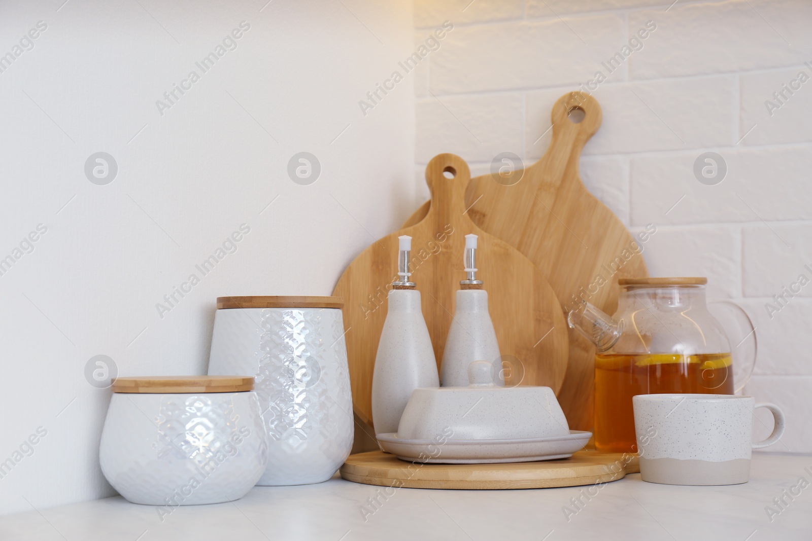 Photo of Wooden boards and different kitchen items on countertop indoors