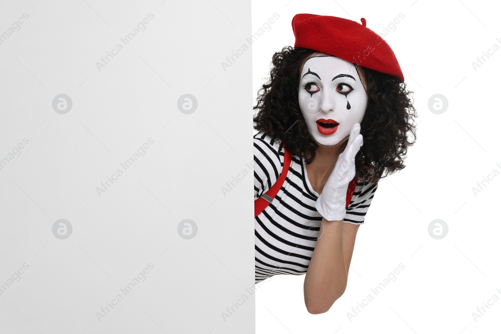 Photo of Funny mime with blank poster posing on white background