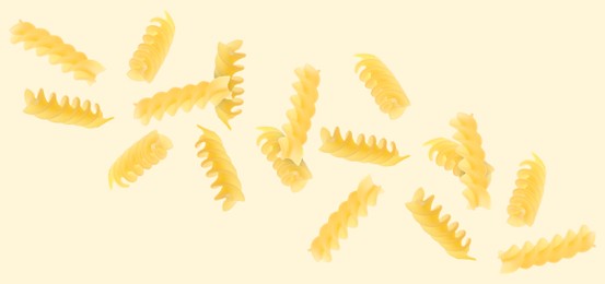 Raw fusilli pasta flying on beige background