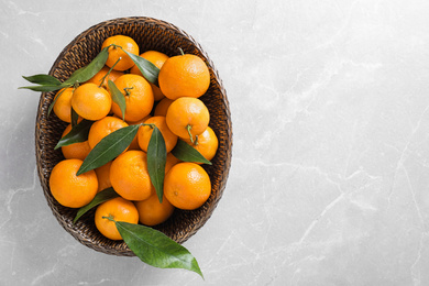 Photo of Fresh ripe tangerines on marble table, top view. Space for text