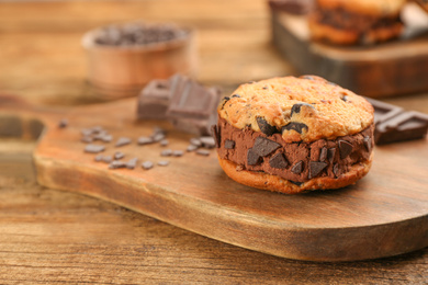 Photo of Sweet delicious ice cream cookie sandwich on wooden table