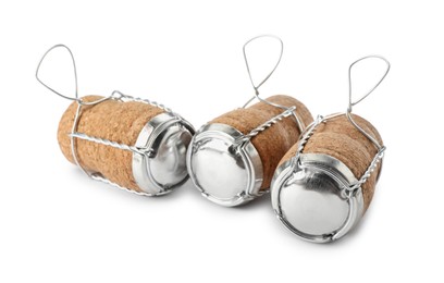 Sparkling wine corks with muselet caps on white background