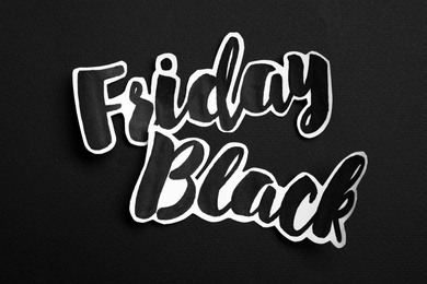 Photo of Phrase Black Friday on dark background, top view