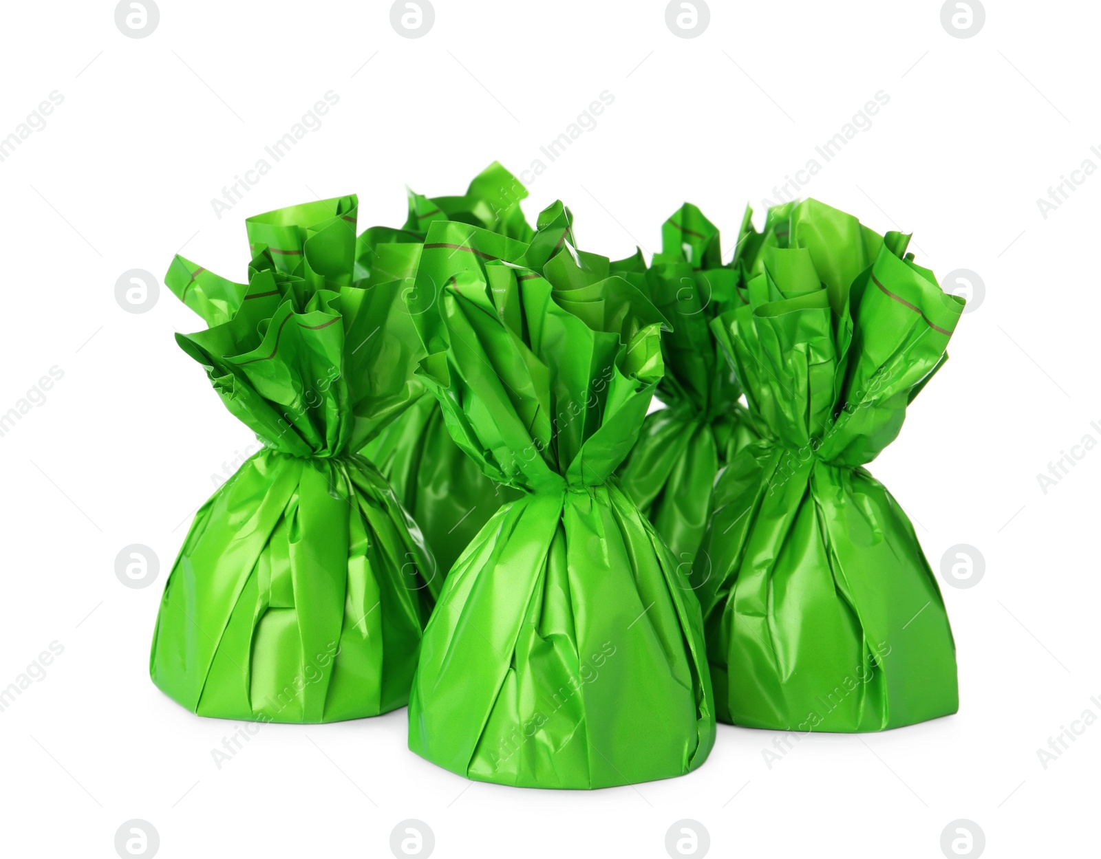 Photo of Delicious candies in green wrappers on white background