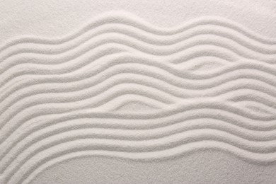 White sand with pattern as background, top view. Concept of zen and harmony