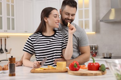 Photo of Lovely young couple cooking together in kitchen