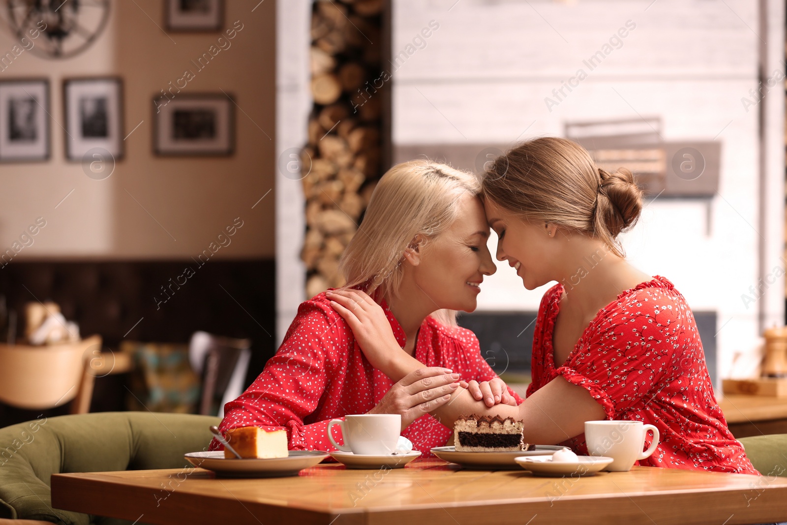 Photo of Mother and her adult daughter spending time together in cafe