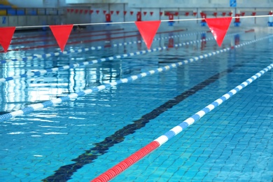 Modern swimming pool with blue water, indoors