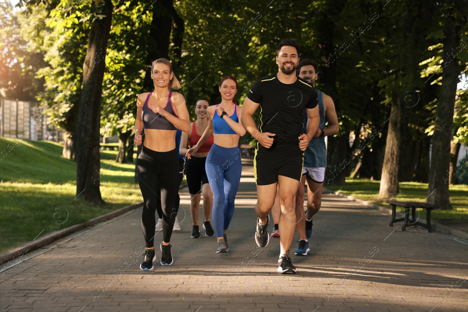 Photo of Group of people running in park. Active lifestyle