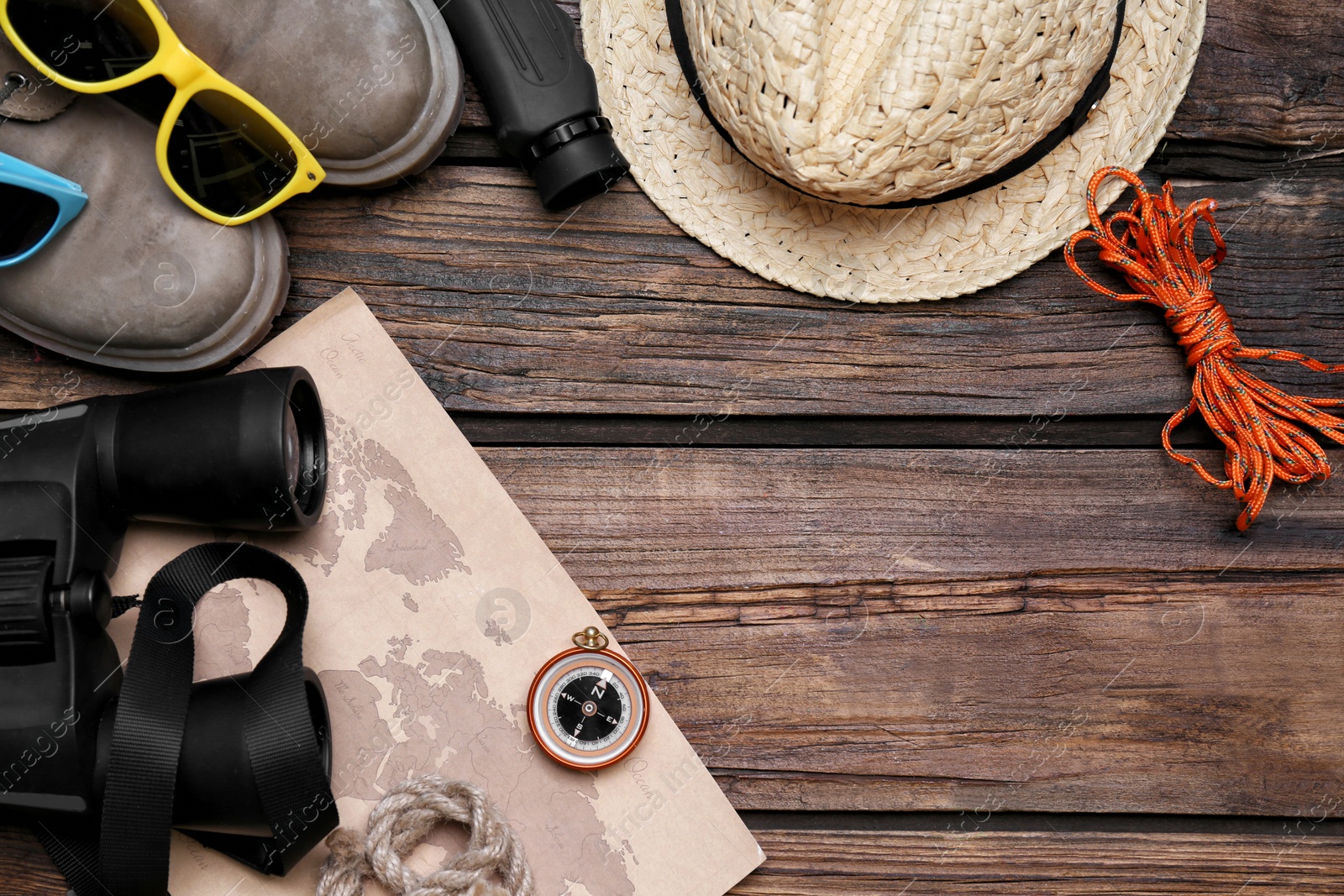 Photo of Flat lay composition with camping equipment on wooden background