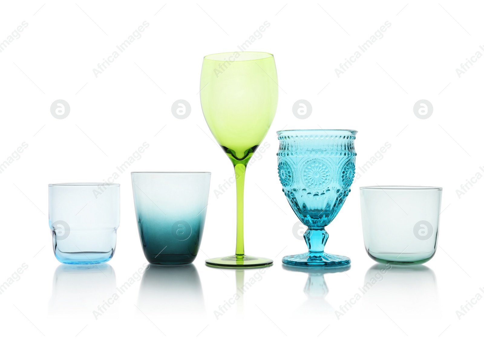 Photo of Set of colorful empty glasses on white background