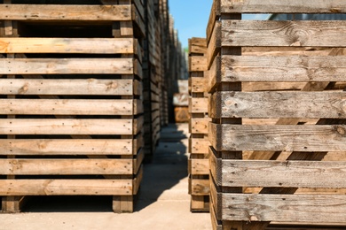 Old empty wooden crates outdoors on sunny day