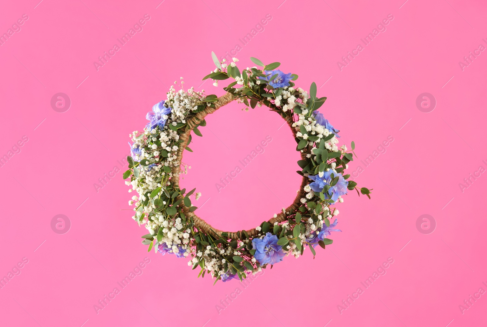 Photo of Beautiful handmade flower wreath on pink background