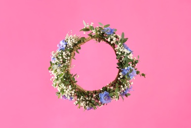 Beautiful handmade flower wreath on pink background