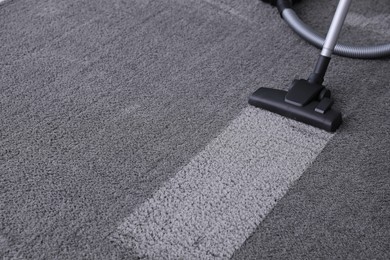 Photo of Modern vacuum cleaner on carpet. Space for text