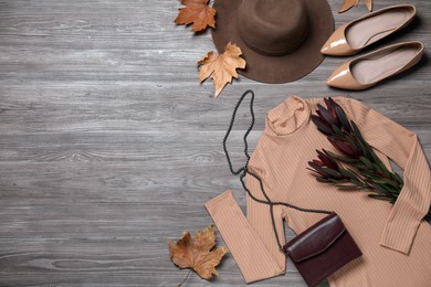 Photo of Fall fashion. Layout of women's outfit on wooden background, top view. Space for text