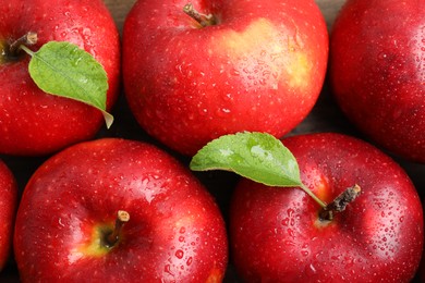 Delicious ripe red apples with water drops on table, flat lay