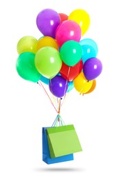 Image of Bunch of color balloons and paper bags on white background