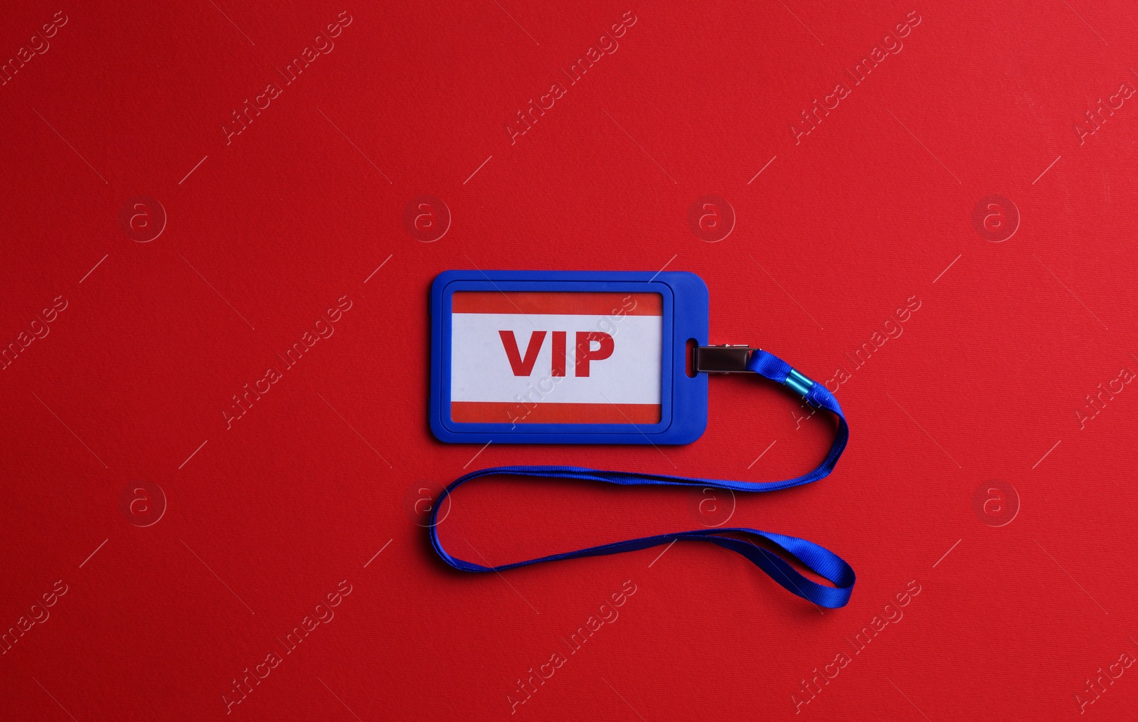 Photo of Plastic vip badge on red background, top view