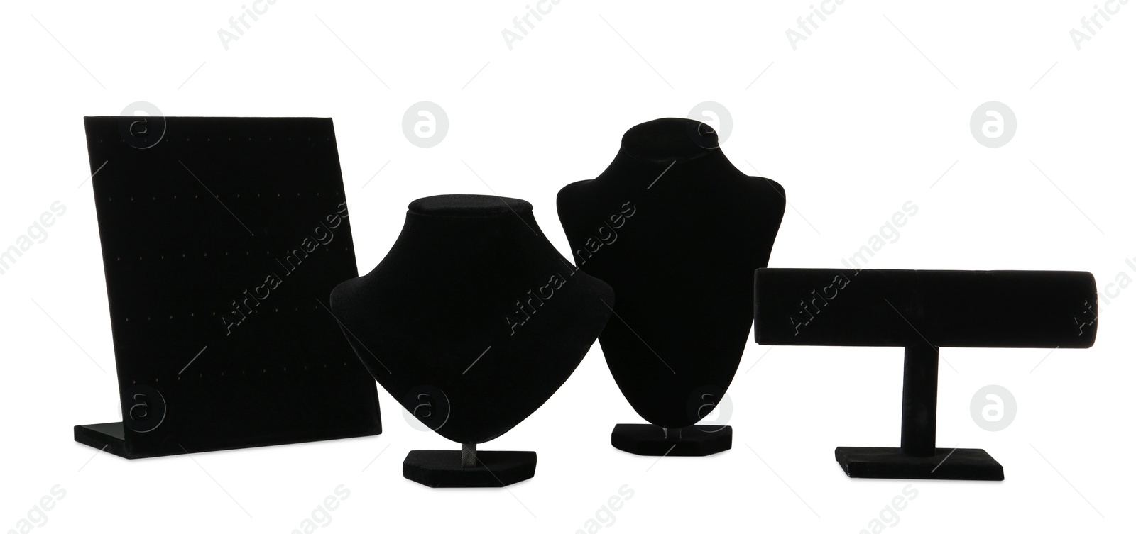 Photo of Different empty black velvet jewelry stands on white background