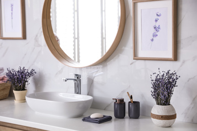 Photo of Mirror and counter with vessel sink in stylish bathroom interior. Idea for design