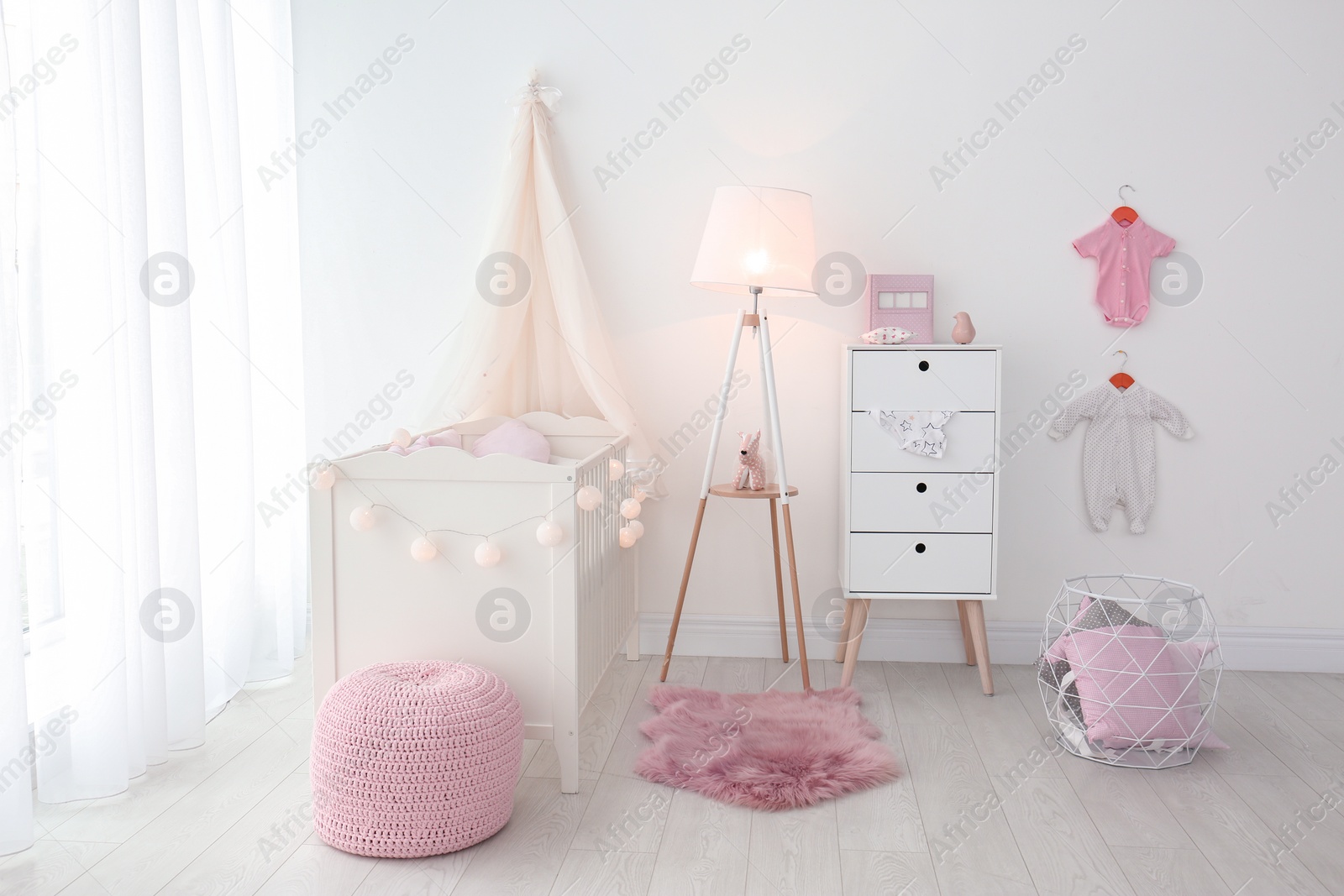 Photo of Interior of baby room with comfortable crib