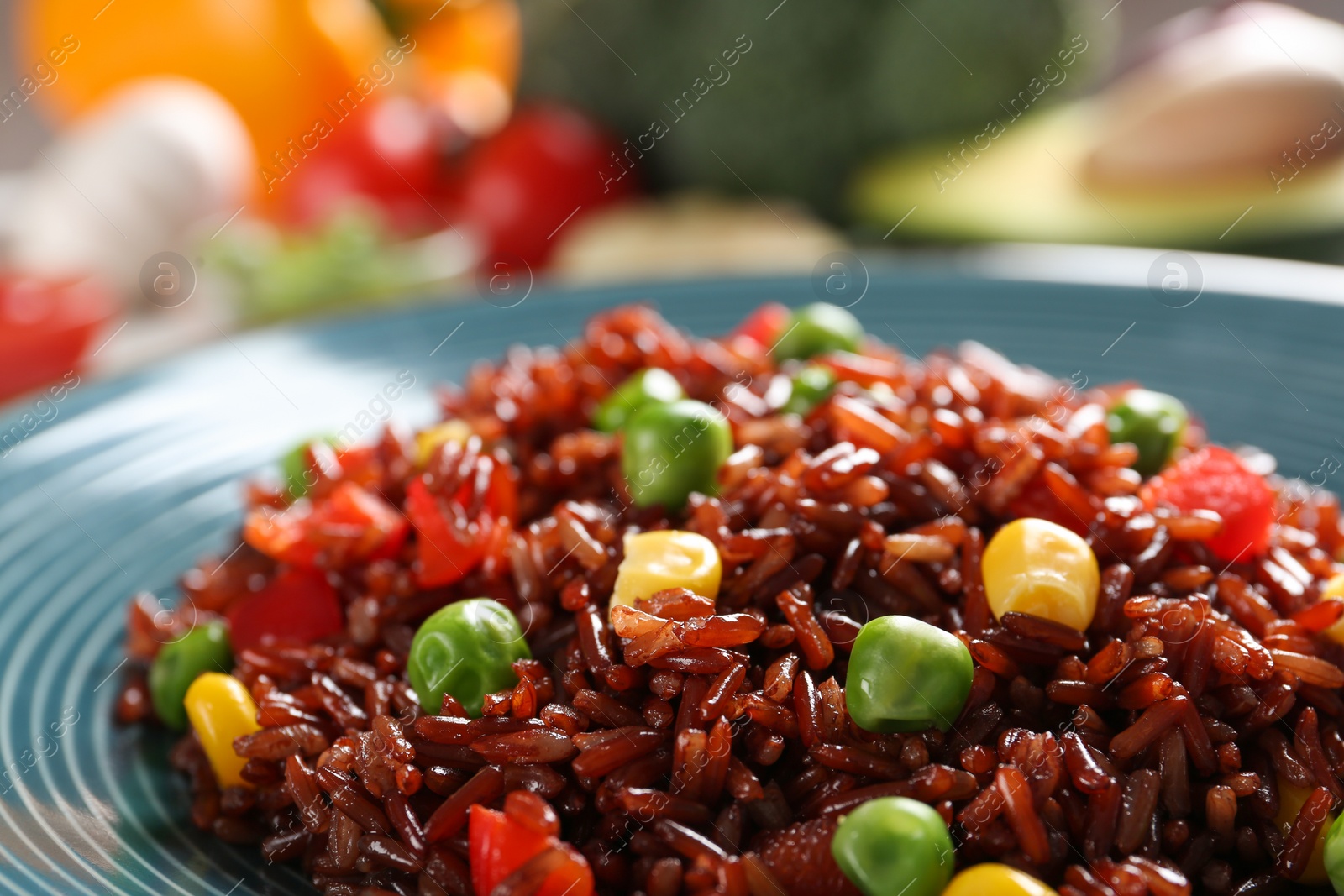 Photo of Boiled brown rice with vegetables in plate, closeup