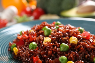 Photo of Boiled brown rice with vegetables in plate, closeup