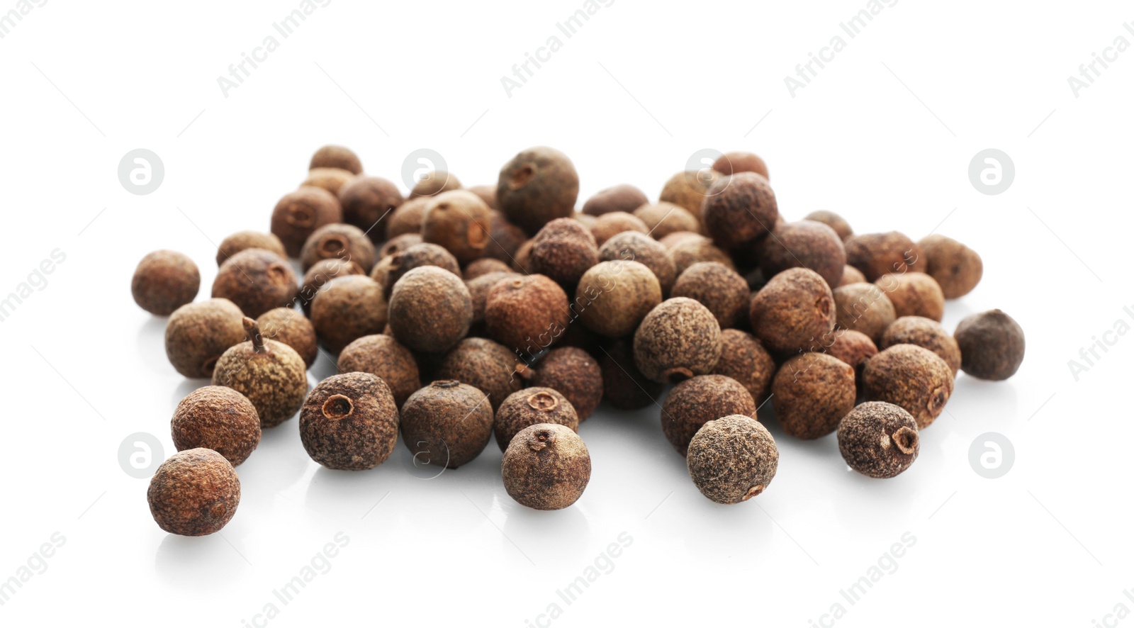 Photo of Allspice pepper grains on white background. Natural spice