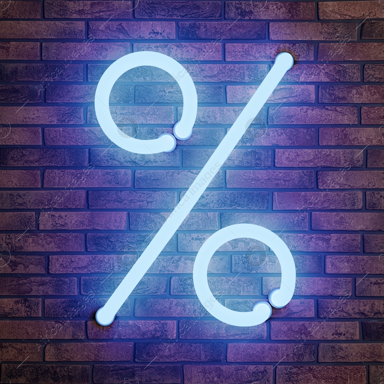 Image of Glowing neon percent sign on brick wall