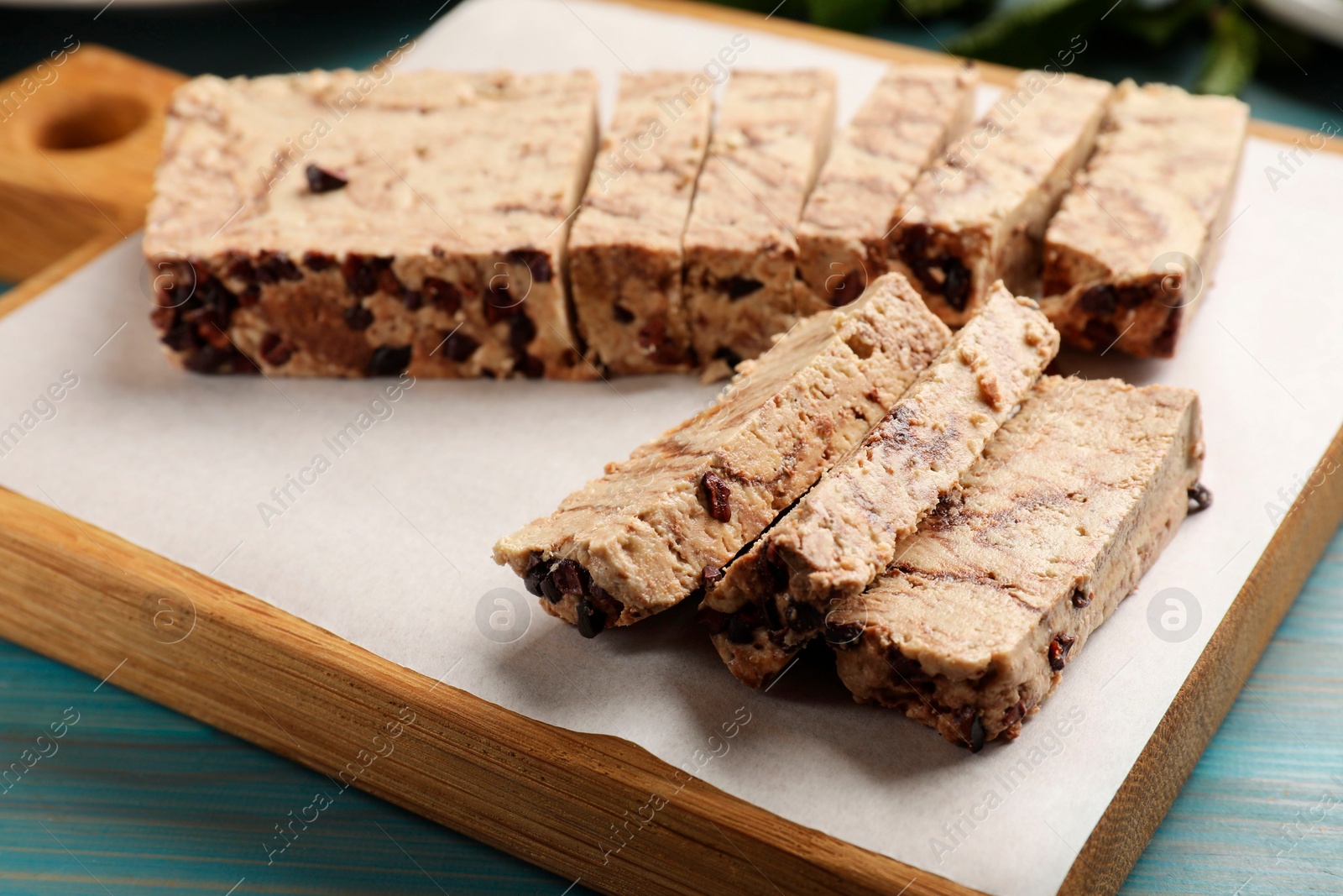 Photo of Pieces of tasty chocolate halva on table, closeup