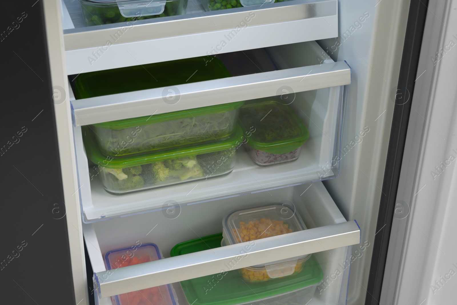 Photo of Plastic and glass containers with different fresh products in fridge. Food storage