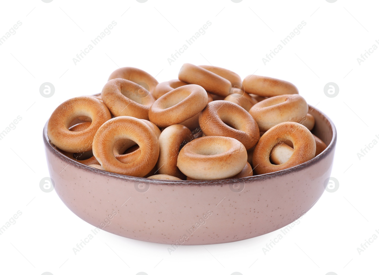 Photo of Bowl with tasty dry bagels (sushki) isolated on white