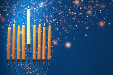 Hanukkah celebration. Menorah with burning candles on blue background, closeup. Space for text