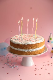 Photo of Tasty cake with colorful candles on pink background