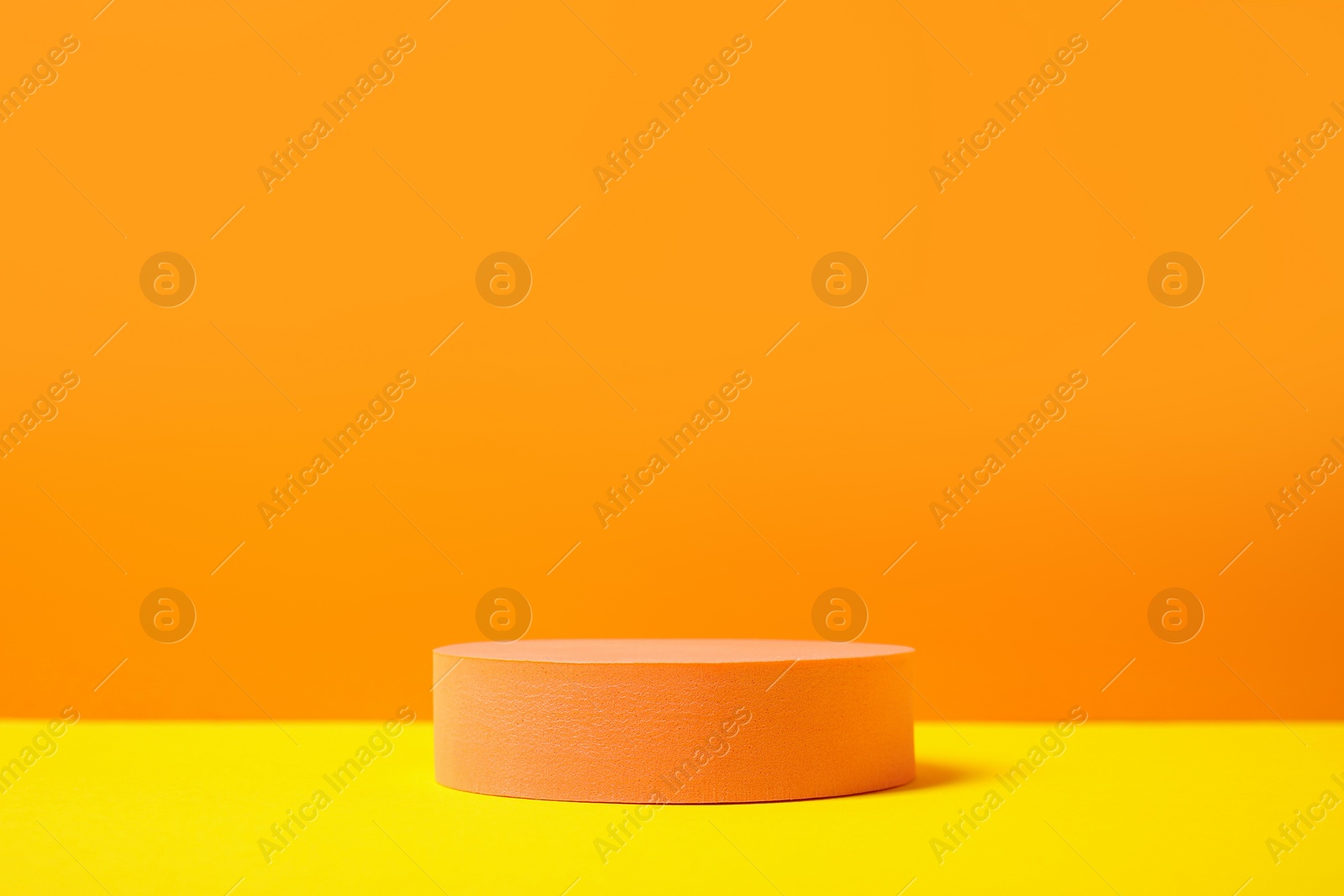 Photo of Round stand on orange background, space for text. Stylish presentation for product