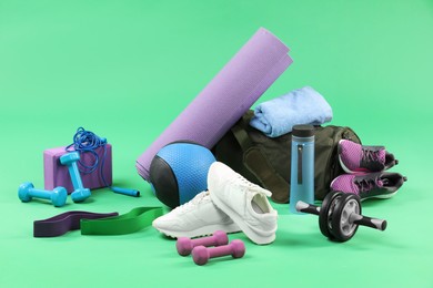 Photo of Many different sports equipment on green background