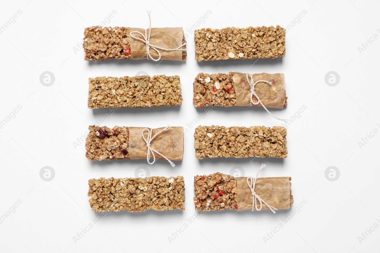 Photo of Different tasty granola bars on white background, flat lay