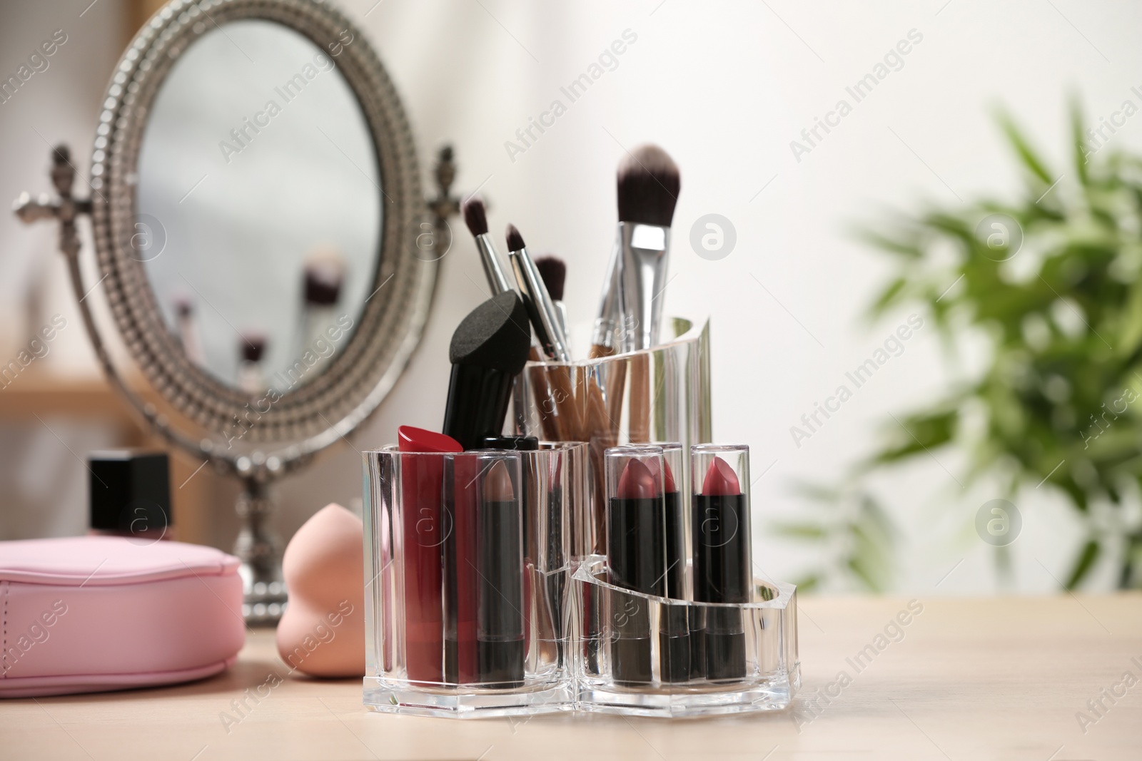 Photo of Set of decorative cosmetic products for makeup on dressing table