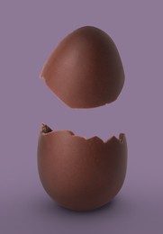Image of Exploded milk chocolate egg on dusty purple background
