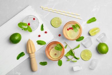 Flat lay composition with delicious natural lemonade on light background